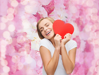 Image showing smiling woman in white t-shirt with heart