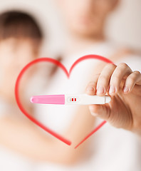 Image showing woman and man hands with pregnancy test