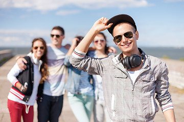 Image showing teenage boy with sunglasses and friends outside