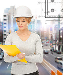 Image showing female contractor in helmet with folder