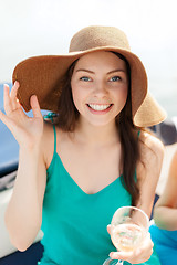 Image showing smiling girl in hat with champagne glass