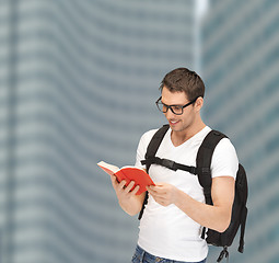 Image showing student in eyeglasses with backpack and book