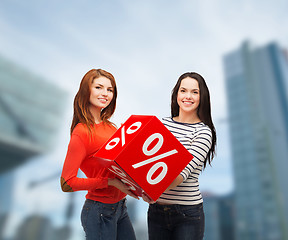 Image showing two smiling teenage girl with percent sign on box