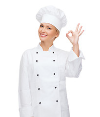 Image showing smiling female chef showing ok hand sign