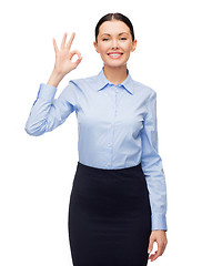 Image showing smiling businesswoman showing ok sign