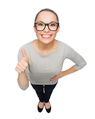 Image showing asian woman in eyeglasses showing thumbs up