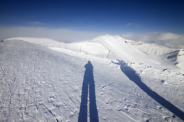 Image showing Shadows of skier and snowboarder on snow