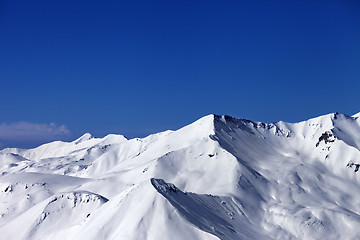 Image showing View on off-piste snowy slope at sunny day