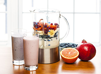 Image showing Making smoothies in blender with fruit and yogurt