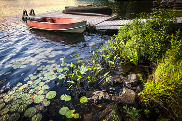 Image showing Rowboat at lake shore at dusk