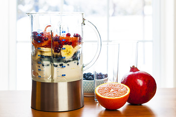 Image showing Preparing smoothies with fruit and yogurt