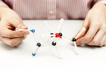 Image showing Student assembling molecule models