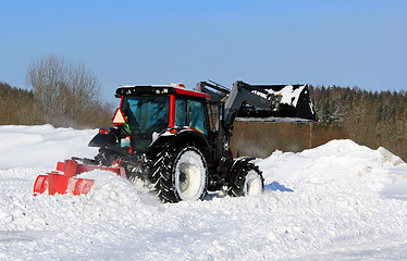 Image showing Tractor Plowing Snow on a Yard