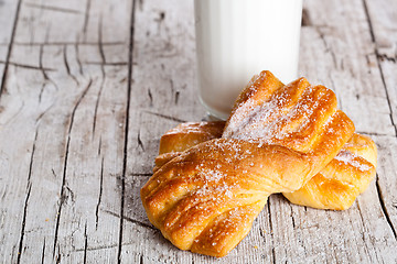 Image showing glass of milk and two fresh baked buns 