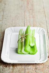 Image showing fresh green celery stems in plate