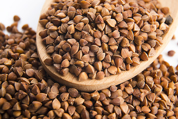 Image showing Buckwheat seeds on wooden spoon in closeup 