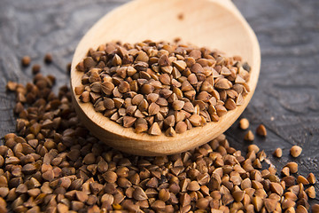 Image showing Buckwheat seeds on wooden spoon in closeup 