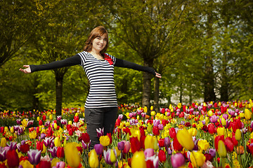 Image showing Woman in the middle of tulips