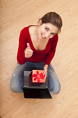 Image showing Woman on the floor with a present