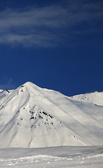 Image showing Ski slope and blue sky with clouds at sunny day