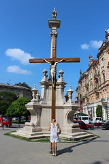 Image showing girl praying near the croos in religious place