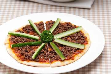 Image showing Turkish beef pizza with cucumber on top