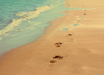 Image showing footprints on sand beach - vintage retro style