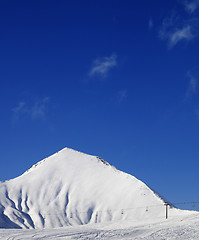 Image showing Ski slope with ropeway at sun winter day