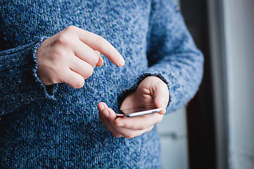 Image showing The man is using a smartphone. Modern mobile phone in hand.