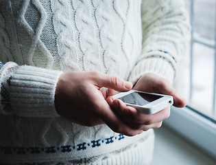 Image showing The man is using a smartphone. Modern mobile phone in hand.