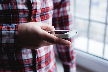 Image showing The man is using a smartphone. Modern mobile phone in hand.