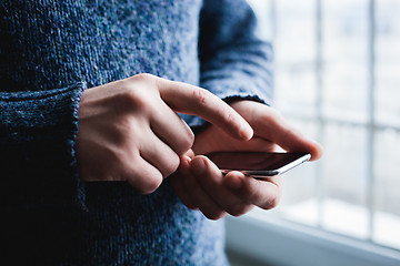 Image showing The man is using a smartphone. Modern mobile phone in hand.