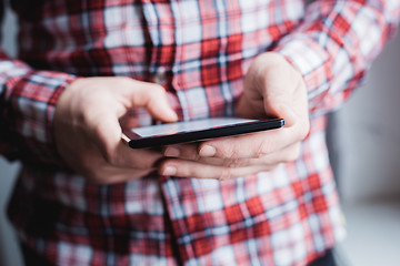 Image showing The man uses a tablet PC. Modern gadget in hand.