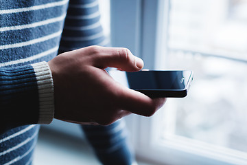 Image showing The man is using a smartphone. Modern mobile phone in hand.