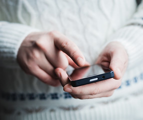 Image showing The man is using a smartphone. Modern mobile phone in hand.