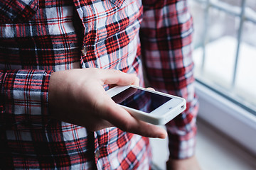 Image showing The man is using a smartphone. Modern mobile phone in hand.