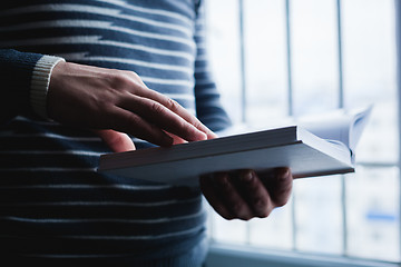 Image showing Man reading. Book in his hands.