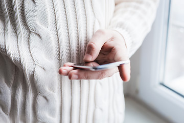 Image showing The man is using a smartphone. Modern mobile phone in hand.