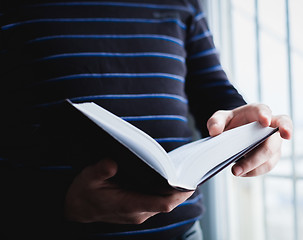 Image showing Man reading. Book in his hands.