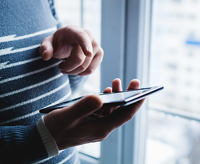 Image showing The man is using a smartphone. Modern mobile phone in hand.