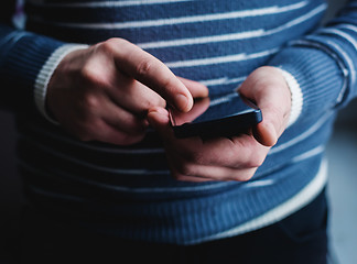 Image showing The man is using a smartphone. Modern mobile phone in hand.