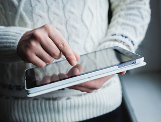 Image showing The man uses a tablet PC. Modern gadget in hand.