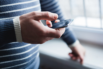 Image showing The man is using a smartphone. Modern mobile phone in hand.