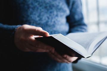 Image showing Man reading. Book in his hands.