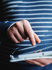 Image showing The man uses a tablet PC. Modern gadget in hand.