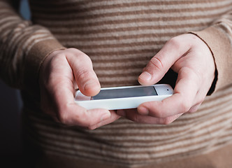 Image showing The man uses a tablet PC. Modern gadget in hand.