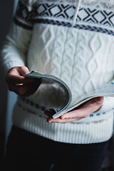 Image showing A man looks at a magazine. Press hands.