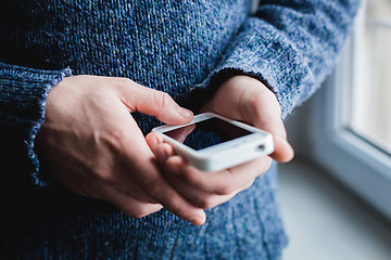 Image showing The man is using a smartphone. Modern mobile phone in hand.