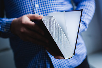 Image showing Man reading. Book in his hands.