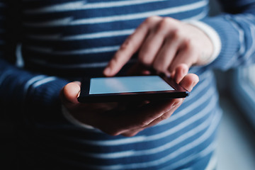 Image showing The man uses a tablet PC. Modern gadget in hand.